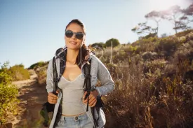 Beautiful hiker woman trekking in nature